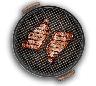 steak sizzling on round grill