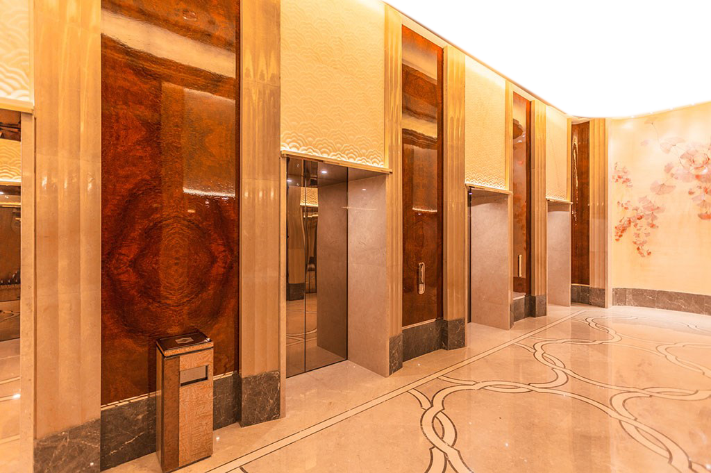 Polished Wood Elevator Doors in Marble Lobby
