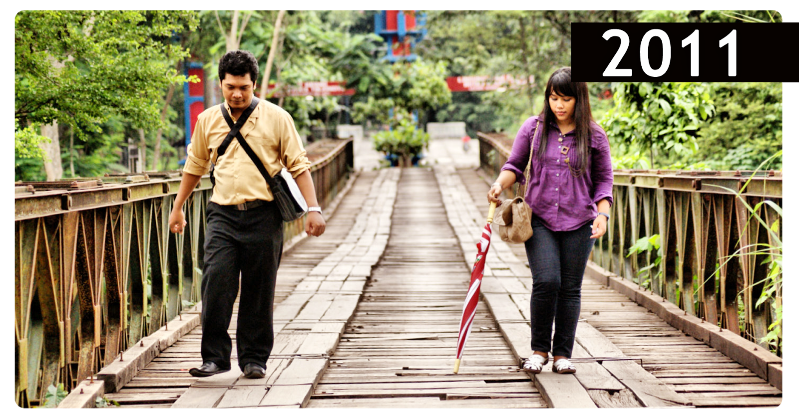 Couple Walking Wooden Footbridge, Red Umbrella