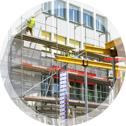Metal Scaffolding with Workers Beside Office Building