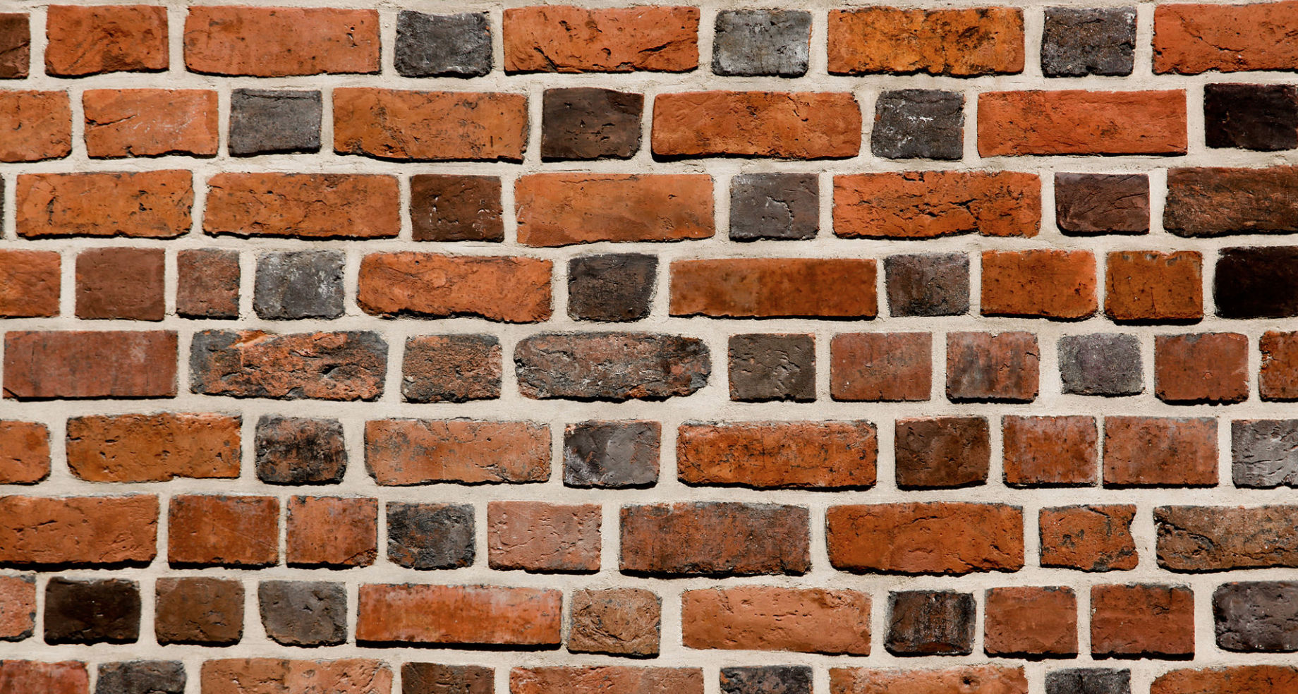 Weathered Orange and Charcoal Brick Wall