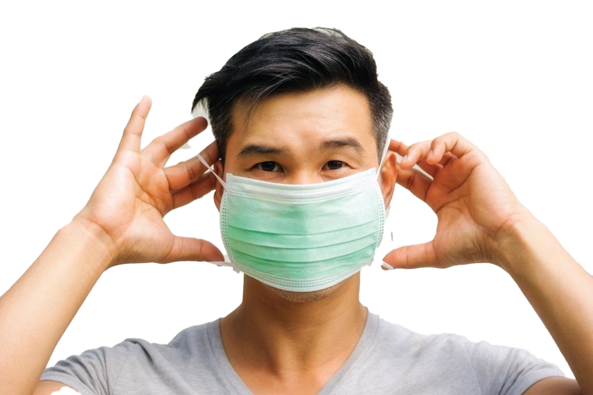 Man Adjusting Green Surgical Face Mask With Both Hands Photo