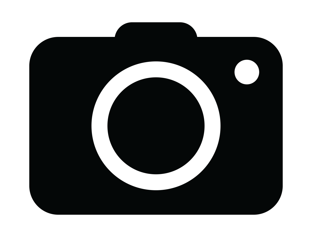 Solid Black Digital Camera Silhouette Icon With Large Lens
