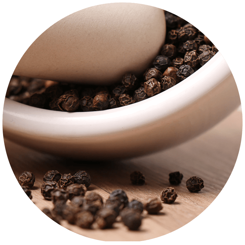 Close Up Bowl Of Dark Whole Peppercorns With Loose Spices Around PNG