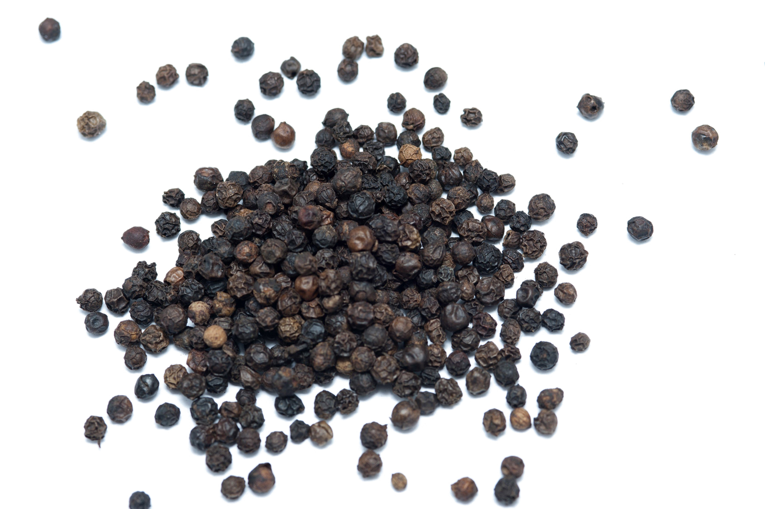 Scattered Black Peppercorns Forming A Small Dark Spice Pile PNG Image