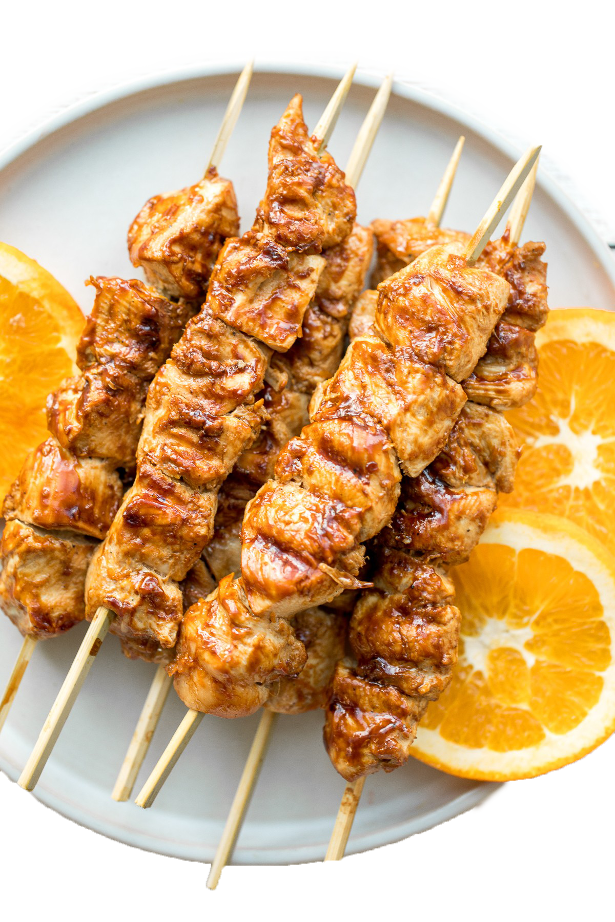 Five Grilled Chicken Kebab Skewers with Lemon on White Platter PNG Food Photo