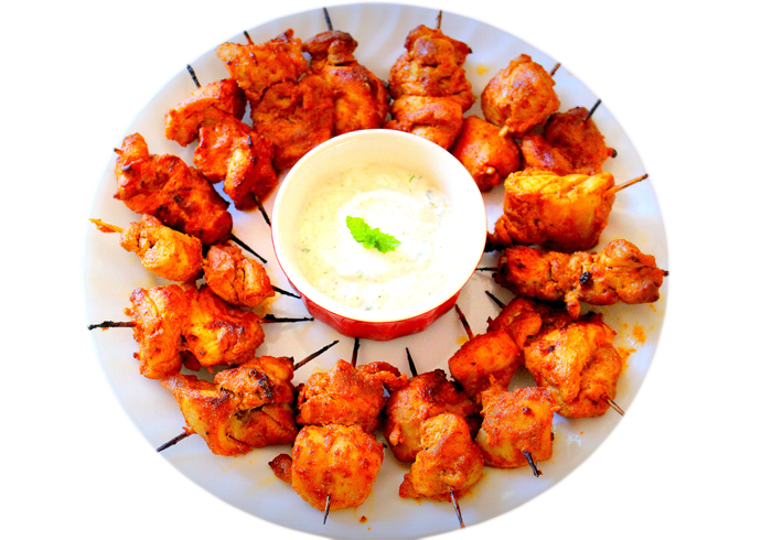 Spicy Chicken Tikka Kebab Bites with Onion and Lemon on Plate PNG Image