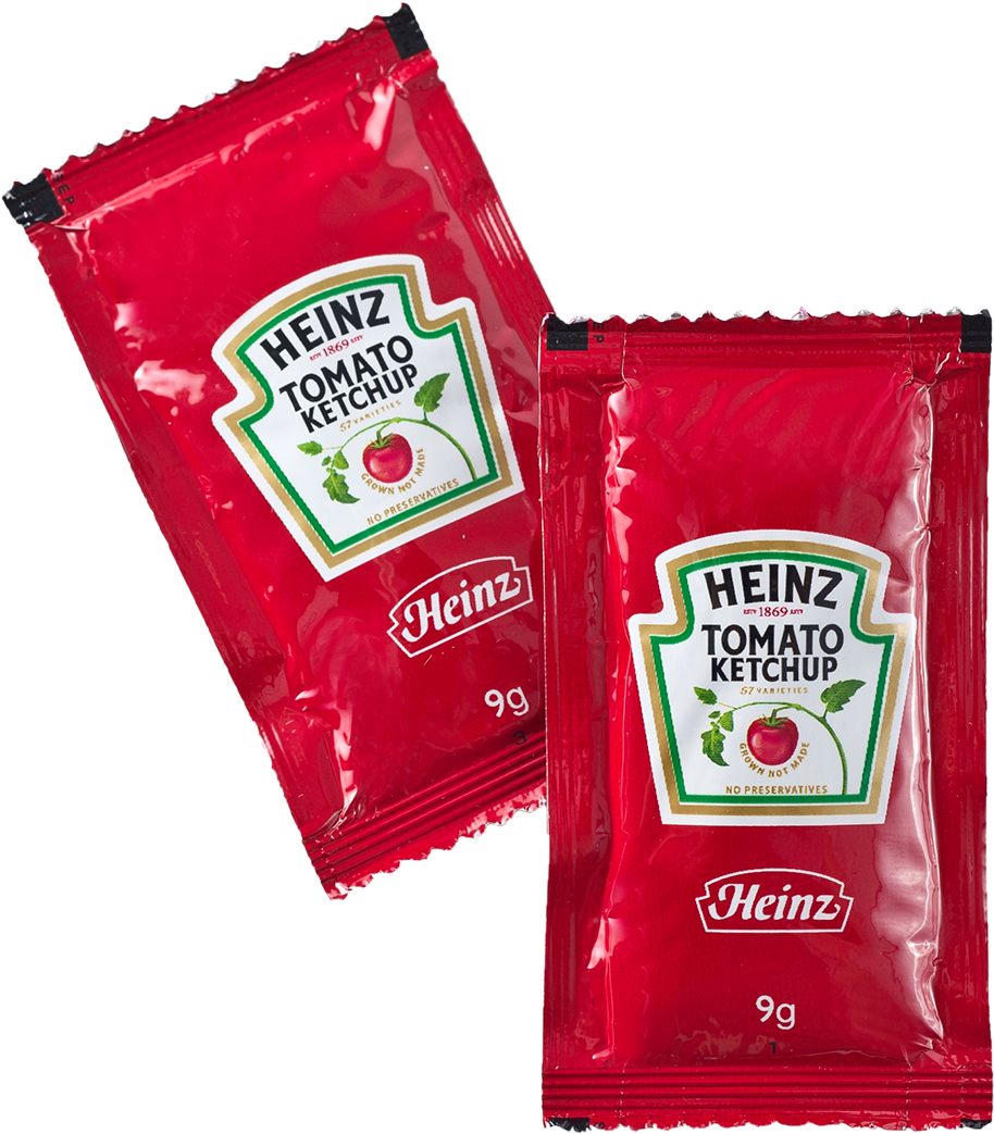 Two Heinz Tomato Ketchup Foil Sachets with White Green Labels PNG Product Image