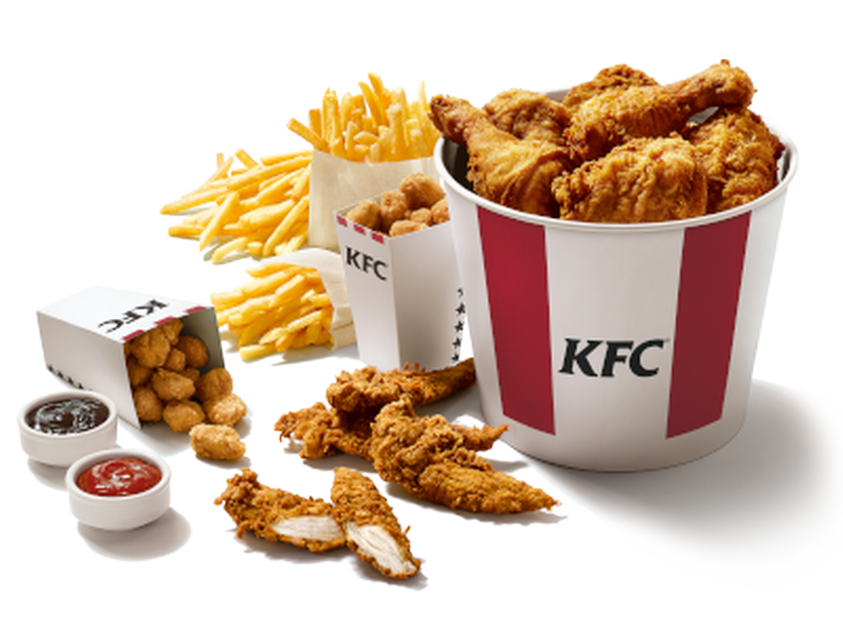 Large KFC Family Meal Spread with Chicken Bucket Sandwiches and Side Dishes PNG