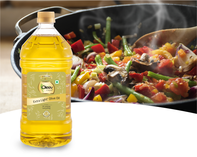 Olive Oil Bottle Beside Fresh Salad Cooking in Pan PNG Image
