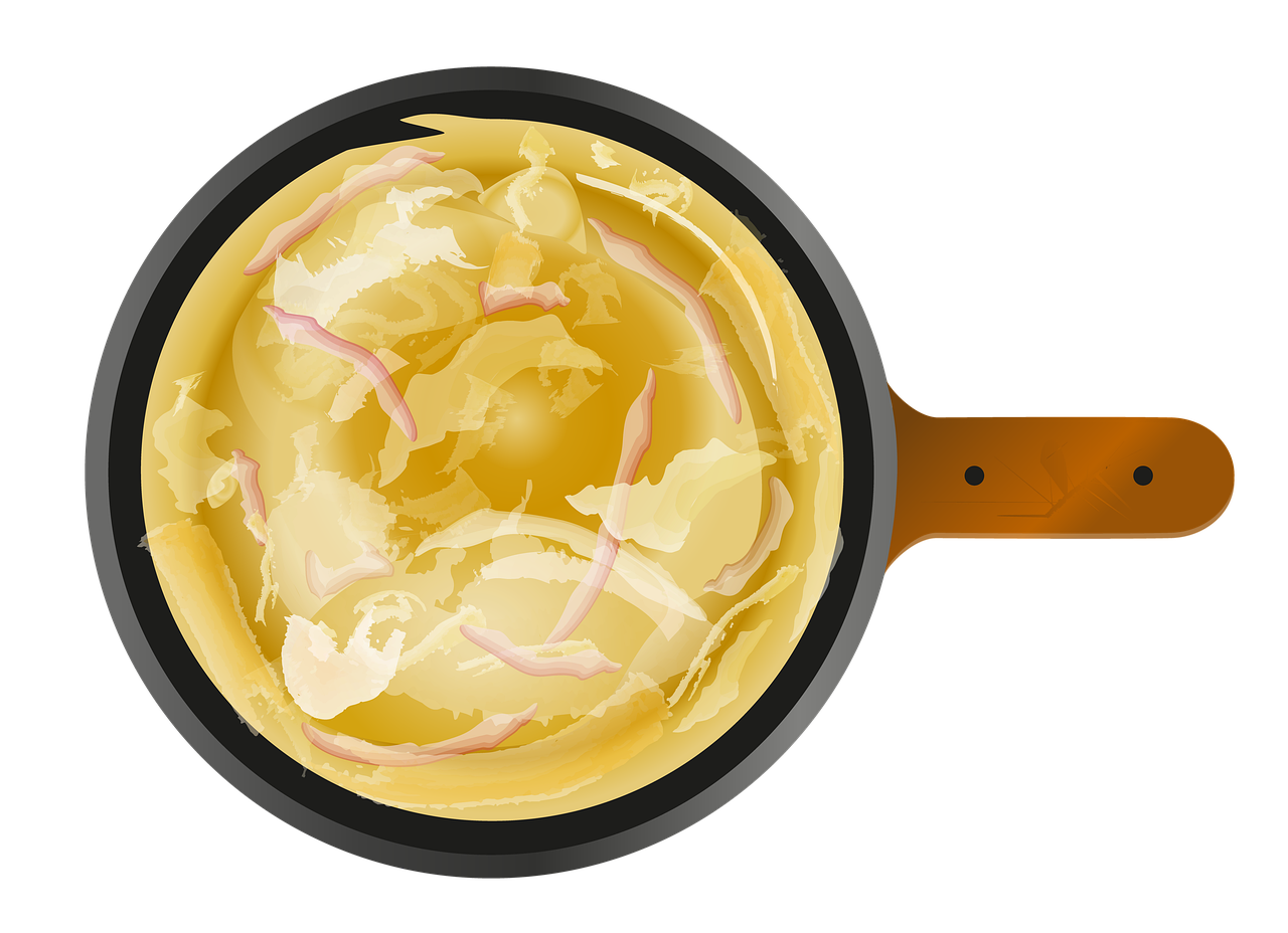 Creamy Golden Egg Mixture Cooking in Small Black Frying Pan PNG Image